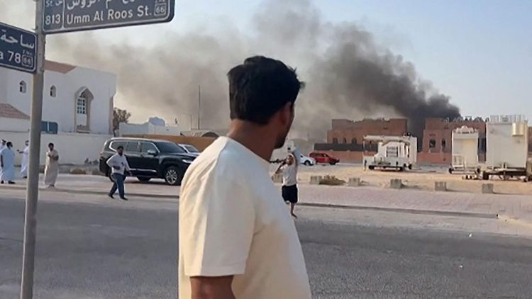 This frame grab taken from an AFPTV footage shows a man looking at smoke billowing after explosions in Doha's capital Qatar on September 9, 2025. An Israeli military official told AFP that the military had carried out air strikes on Doha on September 9 in an operation targeting senior leaders of Palestinian militant group Hamas. (Photo by Jacqueline PENNEY / AFPTV / AFP)